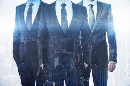 Businessmen on abstract city background. Meeting and teamwork concept. Double exposure の写真素材