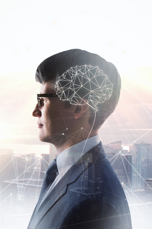 Side view of handsome young european businessman with polygonal brain standing on abstract city background. AI and technology concept. Double exposure の写真素材
