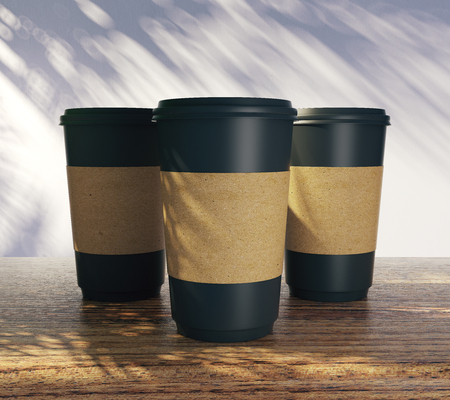 Blank take away coffee cups with palm tree shadow. Advertisement, shop and vacation concept. Mock up, 3D Rendering の写真素材