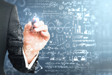 Male hand writing mathematical formulas on blurry background. Science and education concept. Double exposure の写真素材