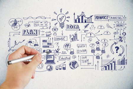 Hand drawing business sketch on concrete wall background. Success and strategy conceptの写真素材