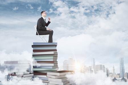 education concept with businessman sitting on pile of books with laptop that found a solution at city background. 3D renderの写真素材