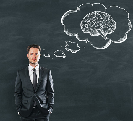 Businessman dreaming about strong brain power at school blackboard background. 3D renderの写真素材