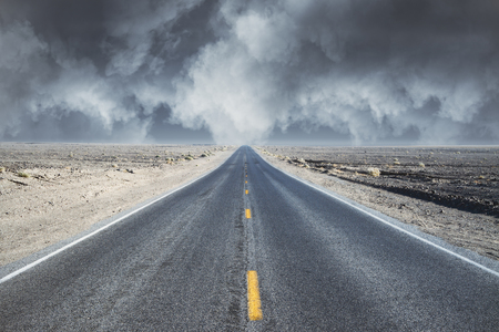 search the road concept with empty road in desert and grey cloudy sky. 3D renderの写真素材