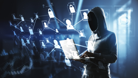 no face hacker in hoody working on latop and abstract digital screen with cyberspace icons and...