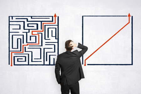 Problem and stress concept. Businessman with creative maze labyrinth sketchの写真素材