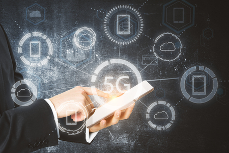 Close up of hand using tablet with glowing 5G internet hologram. Connection and communication...