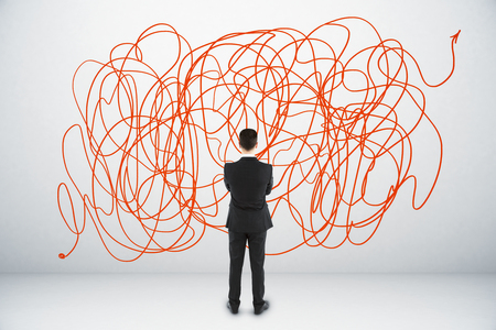 Back view of confused young businessman with scribble sketch. Confusion and challenge conceptの写真素材