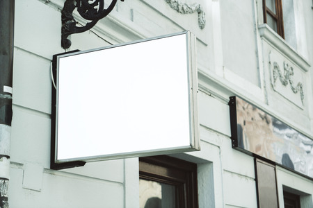 Empty square white banner on building with classical architecture and daylight. Mock upの写真素材