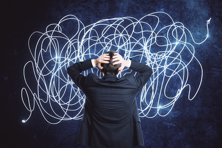 Back view of confused young businessman with scribble sketch. Confusion and think conceptの写真素材