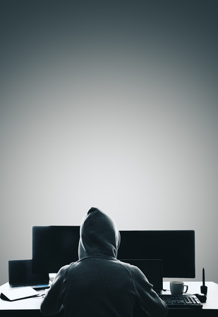 Hacker using computers at dark desk. Hacking and criminal conceptの写真素材