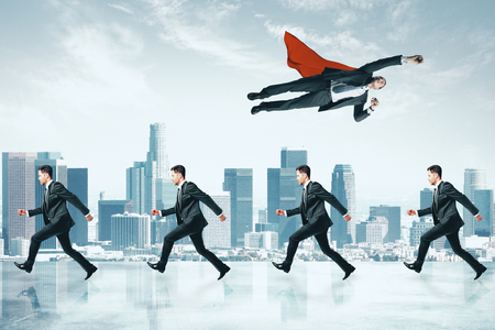 Businessman flying over row of other businessmen on city background. Different direction and leadership conceptの写真素材