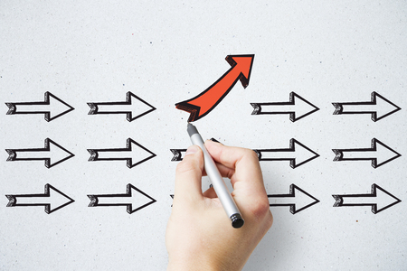 Hand drawing different arrows on light background. Leadership, different direction and choice conceptの写真素材