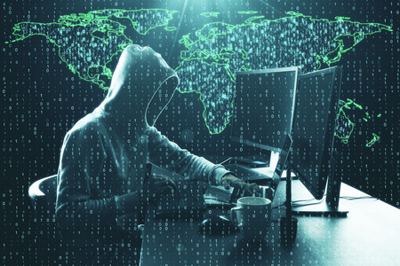 Hacker using computer at desk with map and binary code. Computing and phishing concept. Double...