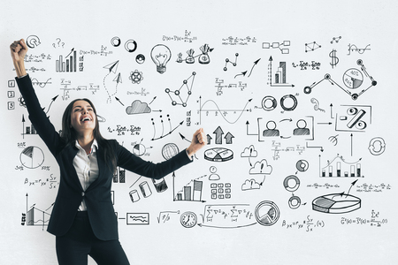 Happy attractive young european businesswoman with business sketch. Success and finance conceptの写真素材