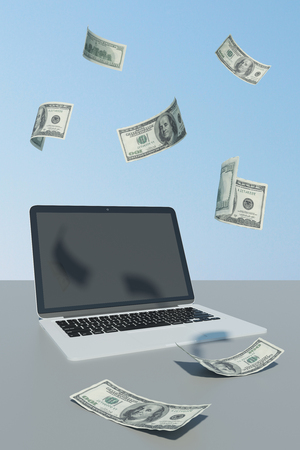 Online payment and money concept. Laptop with abstract dollar bill rain on surface and blue sky background. 3D Renderingの写真素材