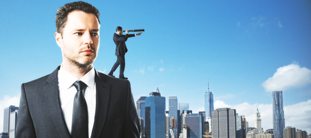 Abstract handsome businessman looking into the distance on city background. Research and watch conceptの写真素材