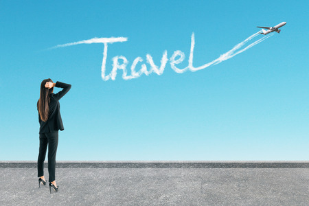 Woman on rooftop with travel pattern and airplane on sky background. Traveling conceptの写真素材