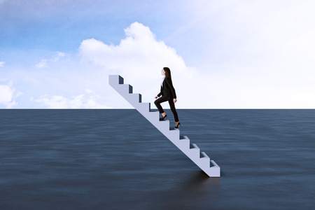 Side view of young businesswoman climbing abstract staircase on sky background. Success and promotion conceptの写真素材