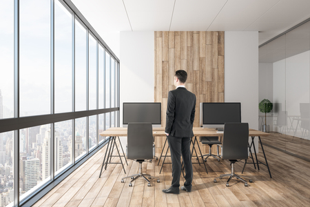 Businessman standing in modern office interior. Boss and executive concept.の写真素材