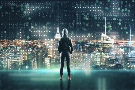 Back view of young hacker standing on abstract new york city circuit background. Hacking and malware concept. Double exposureの写真素材