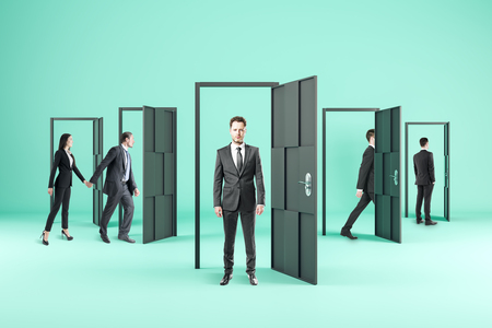 Opportunity, teamwork and occupation concept. Businesspeople in abstract interior with doors.の写真素材