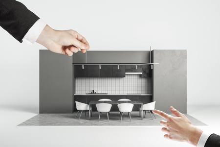 Businessman hands with abstract modern kitchen interior on white background. Engineering and design concept.の写真素材