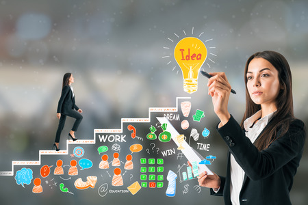 Young businesswoman with business sketch on blurry background. Management and idea conceptの写真素材
