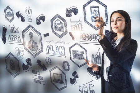 Young businesswoman with business sketch on blurry background. Management and workshop conceptの写真素材