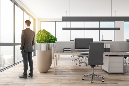 White businessman standing in modern office interior. Research and boss concept.の写真素材