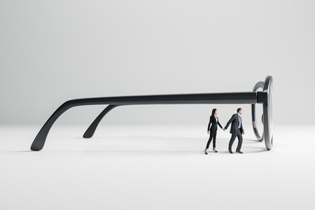 Young businessman and woman with huge eyeglasses on white background. Vision, future and teamwork concept.の写真素材