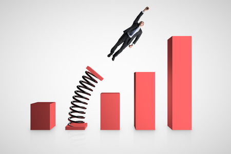 Businessman launching on spring chart. Financial growth and economy concept.の写真素材