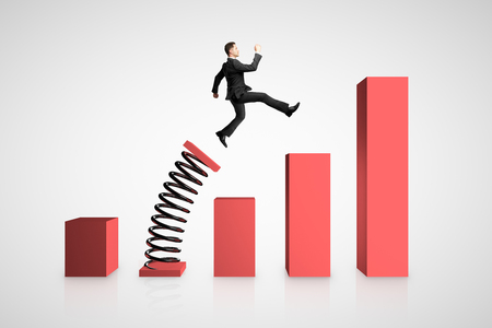 Businessman launching on spring chart. Financial growth and success concept.の写真素材