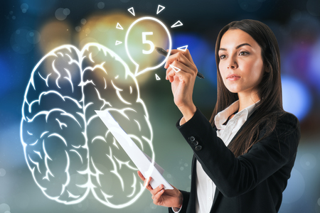 Attractive young european businesswoman drawin brain on blurry background. AI and science conceptの写真素材