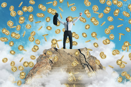 Businessman celebrating golden bitcoin rain on sky background. Cryptocurrency and finance conceptの写真素材