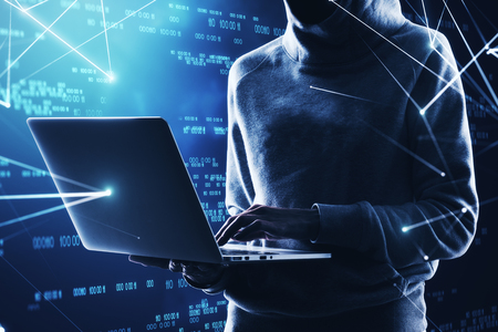 Young hacker using laptop on abstract binary code background. Hacking and computing concept. Double exposureの写真素材