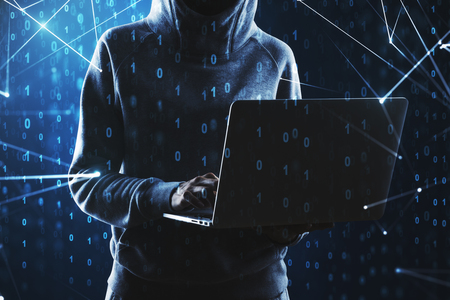 Young hacker using laptop on abstract binary code background. Hacking and criminal concept. Double exposureの写真素材