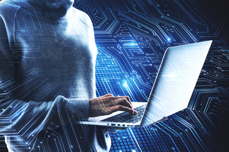 Hacker using laptop with circuit. Computing and future concept. Double exposureの写真素材