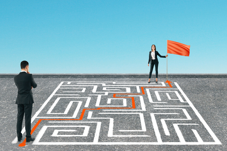 Businesspeople with maze and flag on blue background. Challenge and teamwork conceptの写真素材