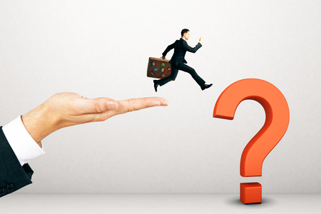 Businessman walking towards question mark on light background. Doubt and confusion conceptの写真素材