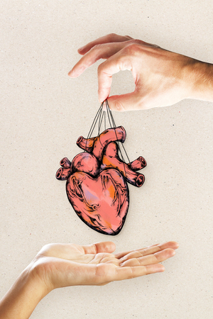 People handing heart sketch on light background. Cardiology and creativity conceptの写真素材