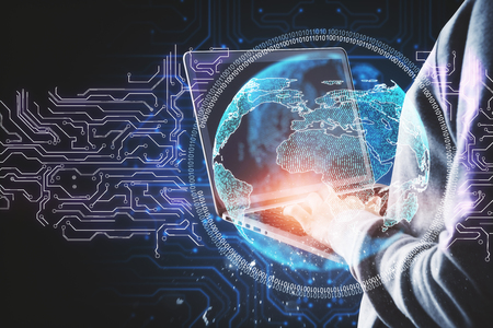 Hacker using laptop with abstract circuit globe. Hacking and information concept. Double exposureの写真素材