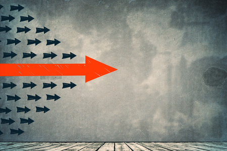 Arrows on concrete wall background. Leadership and direction conceptの写真素材