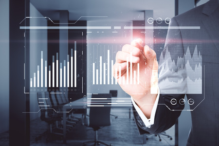 Businessman hand using abstract forex chart interface on blurry office interior background. Innovation and investment concept. Double exposureの写真素材