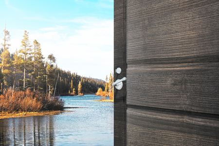 Opening wooden door with creative lake view. Holiday concept. 3D Renderingの写真素材
