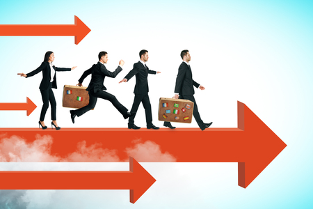 Side view of young businesspeople running on red arrow. Sky background. Teamwork and success conceptの写真素材