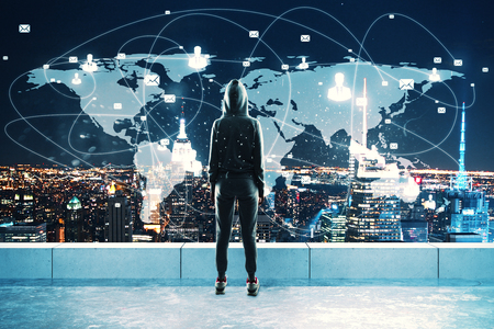 Back view of young hacker on rooftop with night New York city view and digital map. Hacking and global network conceptの写真素材