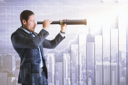 Side view of attractive young businessman using telescope on abstract New York city background with forex chart. Vision and finance concept. Double exposureの写真素材