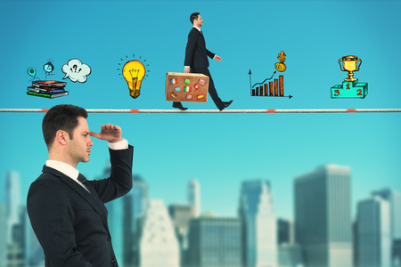 Side view of young businessman looking into the distance on abstract blue sky and blurry city background with business drawing. Research and success conceptの写真素材