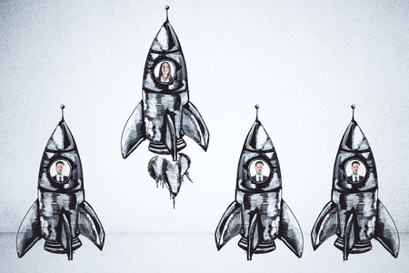 Creative rocket sketch with businesspeople on concrete wall background. Startup and team conceptの写真素材